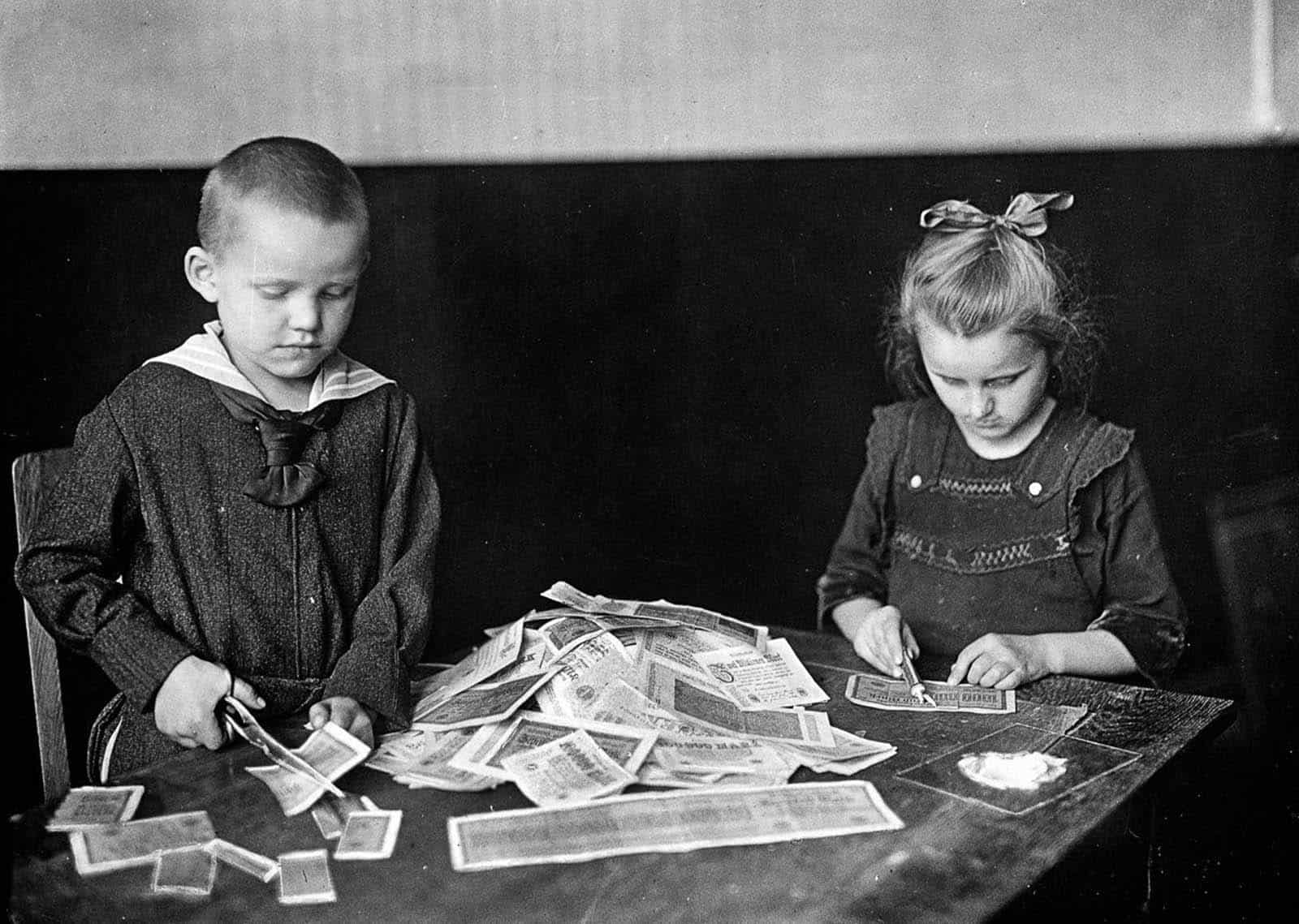Children play with money notes that have lost value under a hyperinflated economy, Germany 1923.