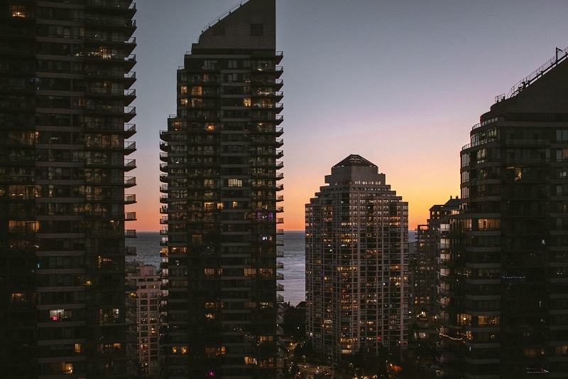 A view of condo housing amid a sunset overlooking Lake Ontario in Toronto