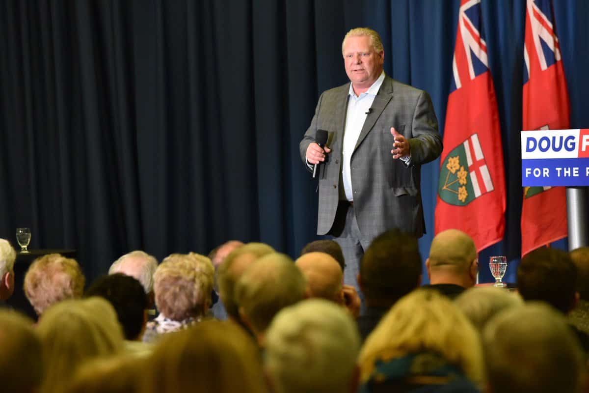 Ontario Premier Doug Ford speaks to a crowd from a stage.