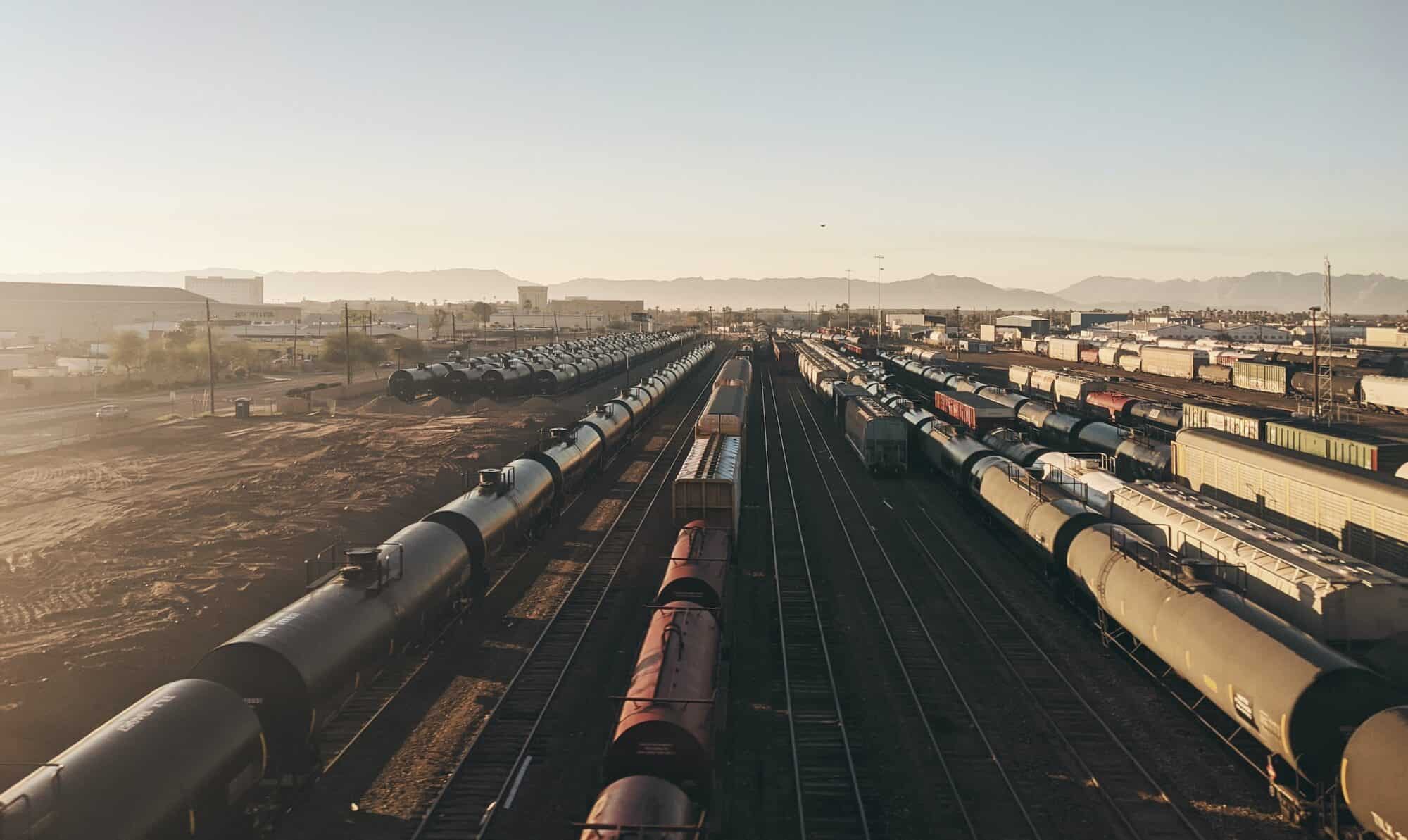 Freight rail cars sit idle in a train yard.