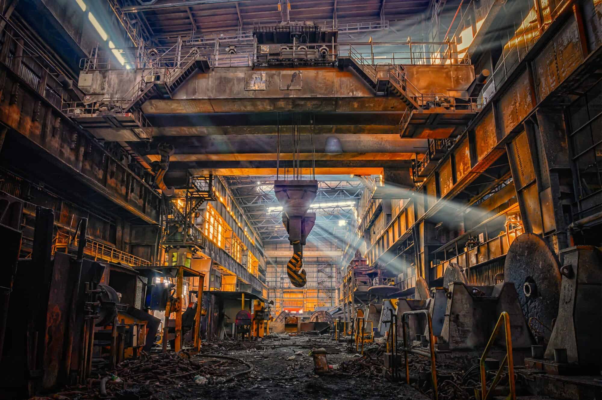 The inside of a derelict old steel mill.